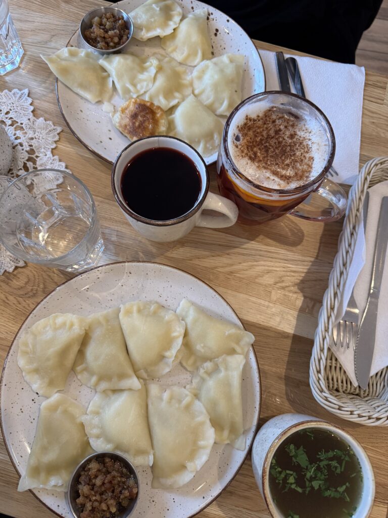 A table filled with Pierogi and soup in Warsaw.